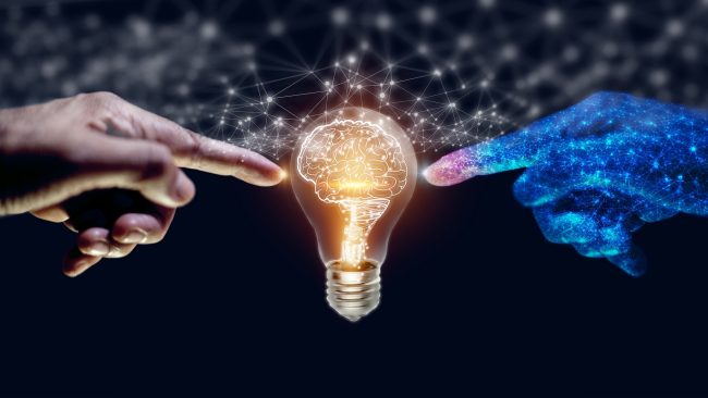 marketing AI automation: A human hand on the left, a digital hand on the right. Both touching a lightbulb with a filament that looks like a brain.